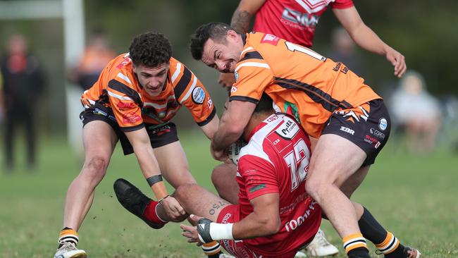 The Entrance’s Joshua Walsh and Hayden Ritchie tackle Kincumber’s Tyson Potger. Picture: Sue Graham