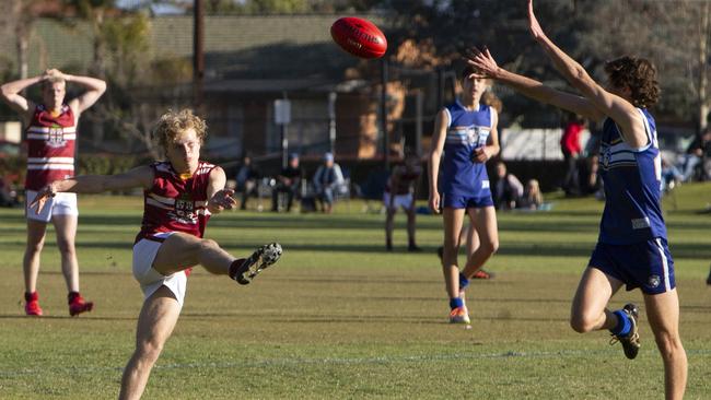 PAC’s Harry Tunkin kicks for goal during the round four college football clash against Sacred Heart. Picture: Emma Brasier