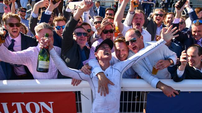 Glen Boss celebrates with racegoers after riding Spanish Mission to finish fourth in his last ever race ride. Picture: Vince Caligiuri/Getty Images