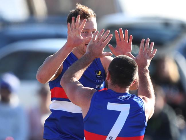 William Goosey (left) celebrates a goal for Mornington.