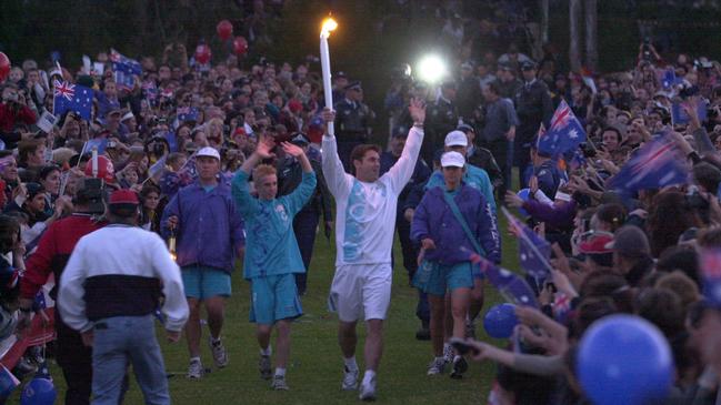 Brad Fittler enters Parramatta Park soaks up the crowd’s cheers during the 2000 Olympic Torch Relay between Kurnell to Parramatta. Picture: Nathan Edwards/News Corp