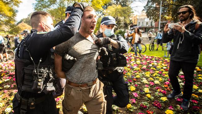 A protester is led away by police in Chippendale. Picture: Julian Andrews