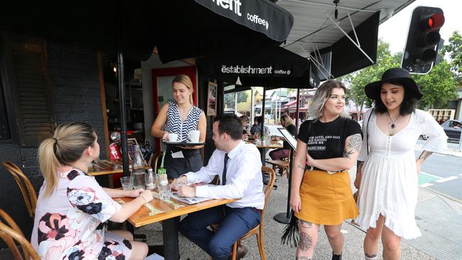 Cafe on the corner of Boundary and Mollison streets. Faye Mehmet, Clarissa Lazzaretti (waitress) and Stephane Mehmet with Emma Zimmerman and Jess Bonney. Picture: Jono Searle.