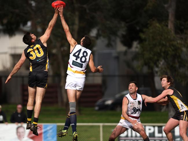 EFL: Balwyn’s Kyle Eliott and Zac Clarke of Doncaster East jump in the ruck. Photo: Hamish Blair