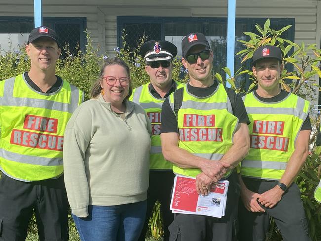 Senior Firefighter Rhett Davis, Superintendant of metropolitan South 3 zone commander Greg Wright, Station officer at Liverpool Fire Station Scott Henderson, Senior FirefigherLuke Marsden and qualified firefigher April Maciejowski with Liverpool resident Amy Bradley.