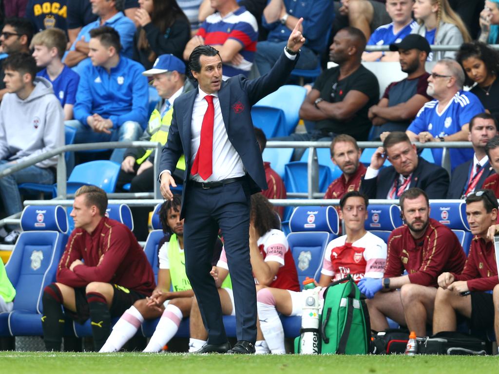 Unai Emery, Manager of Arsenal and Mesut Ozil of Arsenal look on from the touchline during the Premier League match between Cardiff City and Arsenal FC. Picture: Getty Images