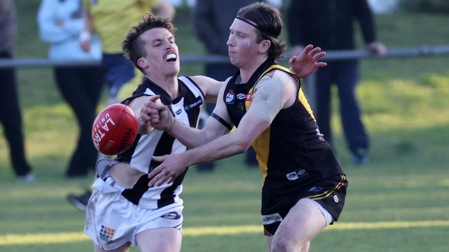 Josh Mills tries to stop Lachlan Wilson. Picture: George Salpigtidis