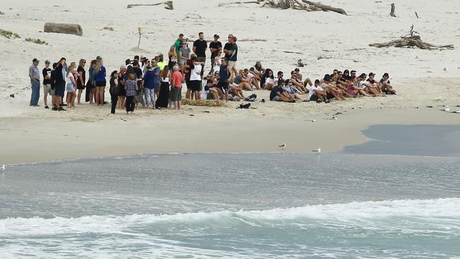 Family and friends hold a memorial for Dylan Carpenter at Fingal beach where the young surfer died. Picture Glenn Hampson