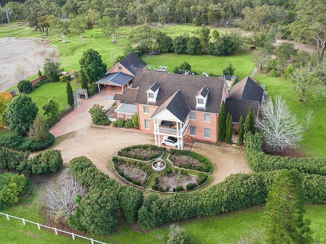 The eight-bedroom, five-bathroom brick house sits amid other acreages. Picture: realestate.com.au