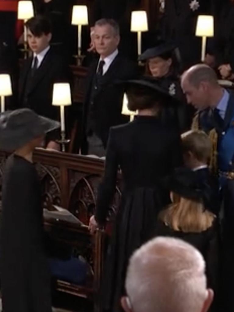 Meghan was seen approaching the Prince and Princess of Wales in the abbey.