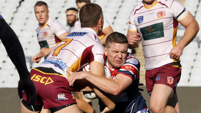 Camden’s Christopher Browne tackled by Damon New. Picture: John Appleyard