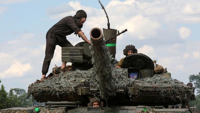 Ukrainian servicemen stand on their tank in Eastern Ukraine last week. Picture: AFP