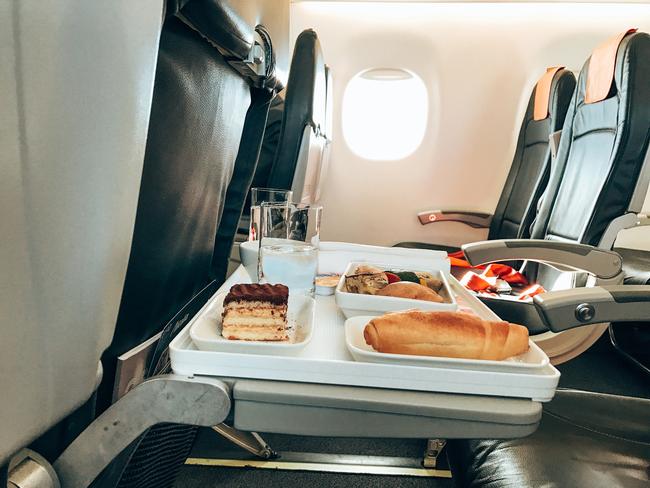 eating in the airplane food tray