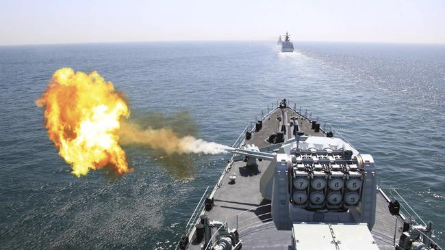 A Chinese navy missile destroyer fires a shell during exercises. Picture: AP