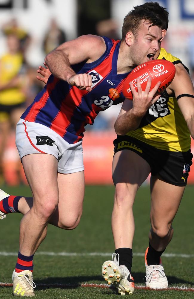 Blake Pearson gets away a handball for Port.