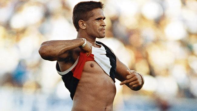 St Kilda player Nicky Winmar points to his skin in response to a racist taunt from the crowd in 1993. Picture: Wayne Ludbey