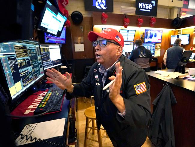 Trader Jonathan Mueller wears a Trump hat as he works on the floor of the New York Stock Exchange (NYSE) at the opening bell on November 6, 2024, in New York City. Wall Street stocks surged in opening trading on Wall Street Wednesday after US voters sent Donald Trump back to the White House and delivered him a Republican Senate. Major indices were up 1.8 percent or more in the early going as hopes about expected tax cuts and regulatory easing more than offset worries about higher tariffs. (Photo by TIMOTHY A. CLARY / AFP)