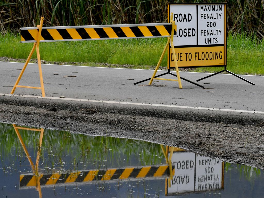 Sunday February 9. Heavy rain causes flooding in North Queensland. Flood warring signs on the Woodstock Giru Road. Picture: Evan Morgan