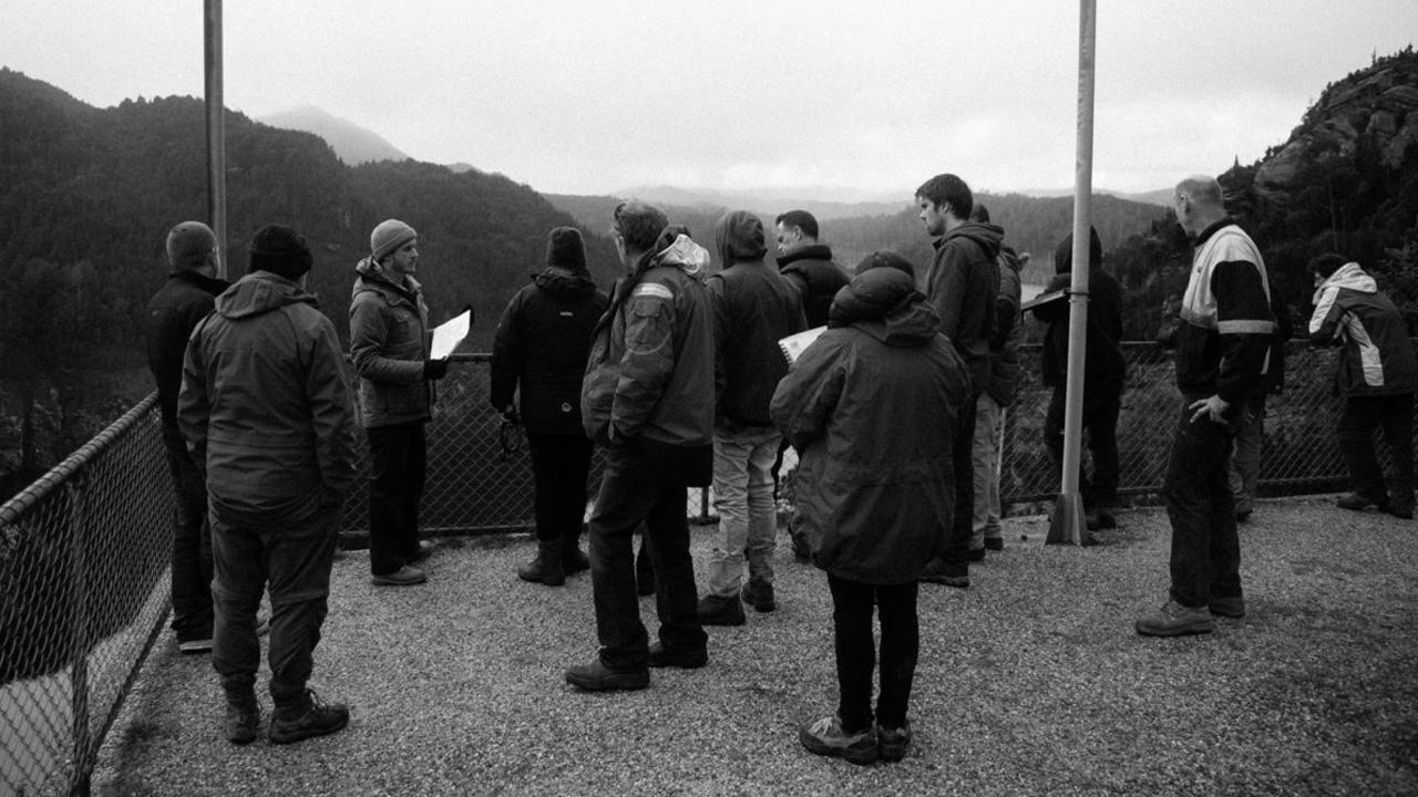 Director Tom Noakes speaks with crew members during a shoot at Gordon Dam in Tasmania.