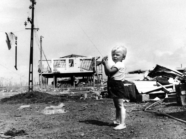 Paul Wauchope (3) flies his kite amid carnage of Cyclone Tracy in Darwin. 25/12/74.         GeneralHistorical Northern Territory / Weather / Cyclones