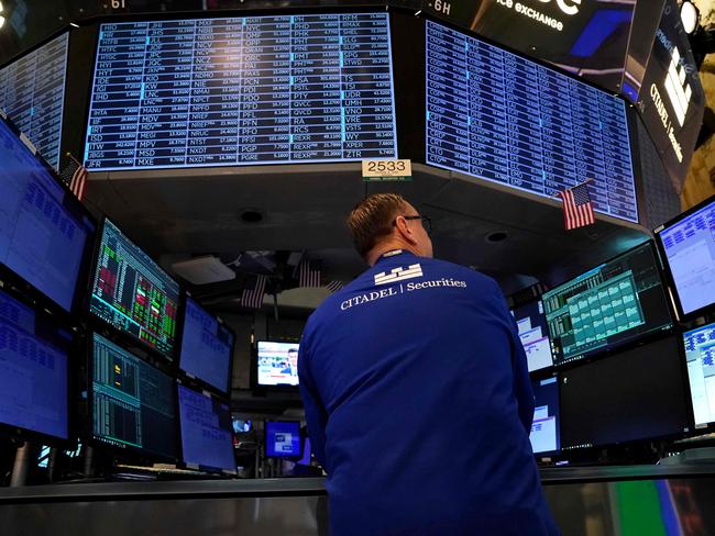 A trader works on the floor of the New York Stock Exchange (NYSE) in New York City on July 22, 2024. Wall Street stocks opened higher early Monday as tech shares bounced back after a recent pullback, as investors looked ahead to major earnings and economic data due this week. The US presidential race had produced a surprise over the weekend with Joe Biden bowing out of the race and throwing support to Vice President Kamala Harris. (Photo by TIMOTHY A. CLARY / AFP)