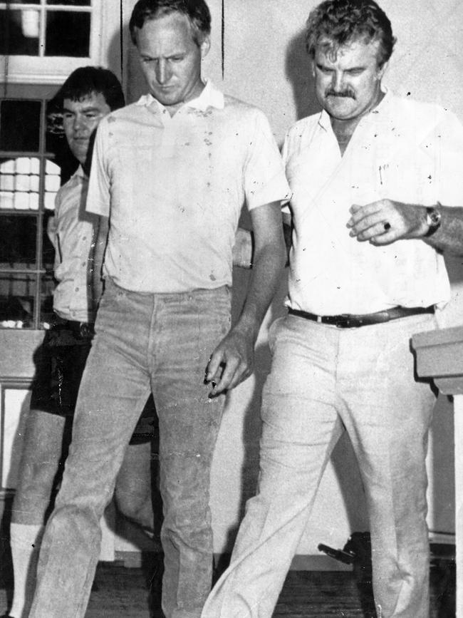 John Malcolm West is taken into a Cairns court for a bail application hearing in 1985. (Brisbane Courier pic)