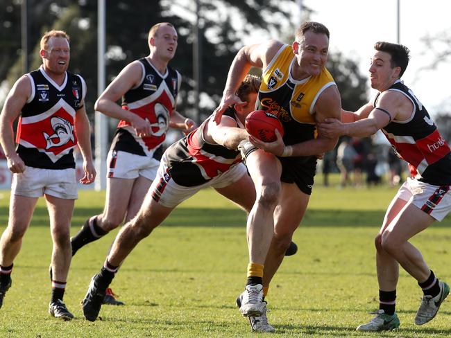 Ash Eames of YCW bursts through a pack against Bonbeach in the 2017 grand final. Picture: Mark Dadswell