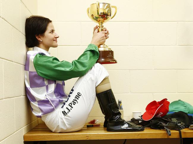 Michelle Payne has a quiet moment with the Melbourne Cup after winning on Prince Of Penzance. Picture: Colleen Petch