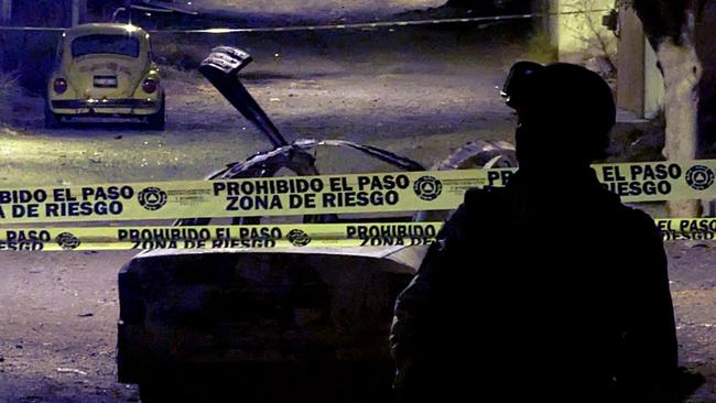 A member of the National Guard stands guard at the zone where a car bomb exploded in Celaya, Guanajuato state, in June. Mora wanted the children of others to enjoy simple lives of peace and justice, despite losing his own son. Picture: AFP