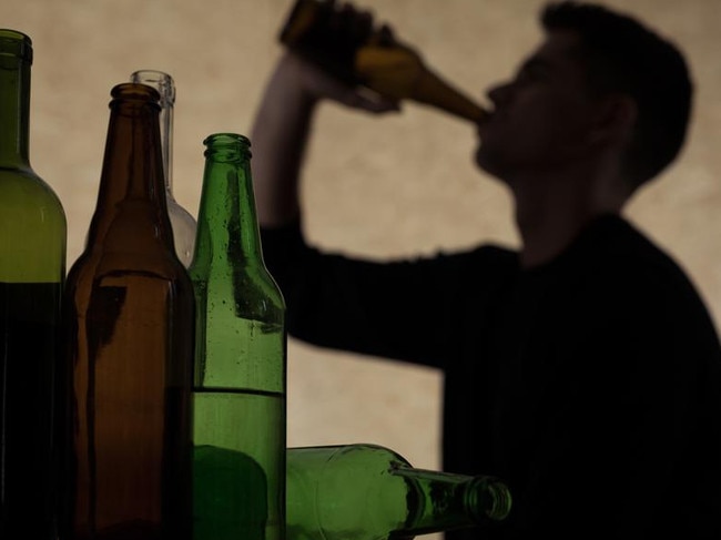 Alcoholism among young people - teenager drinking beer