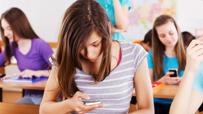 Teaching kids how to use phones responsibly, and educating them about cyber safety, is better preparation for life beyond school than a ban on mobiles. Picture: iStock