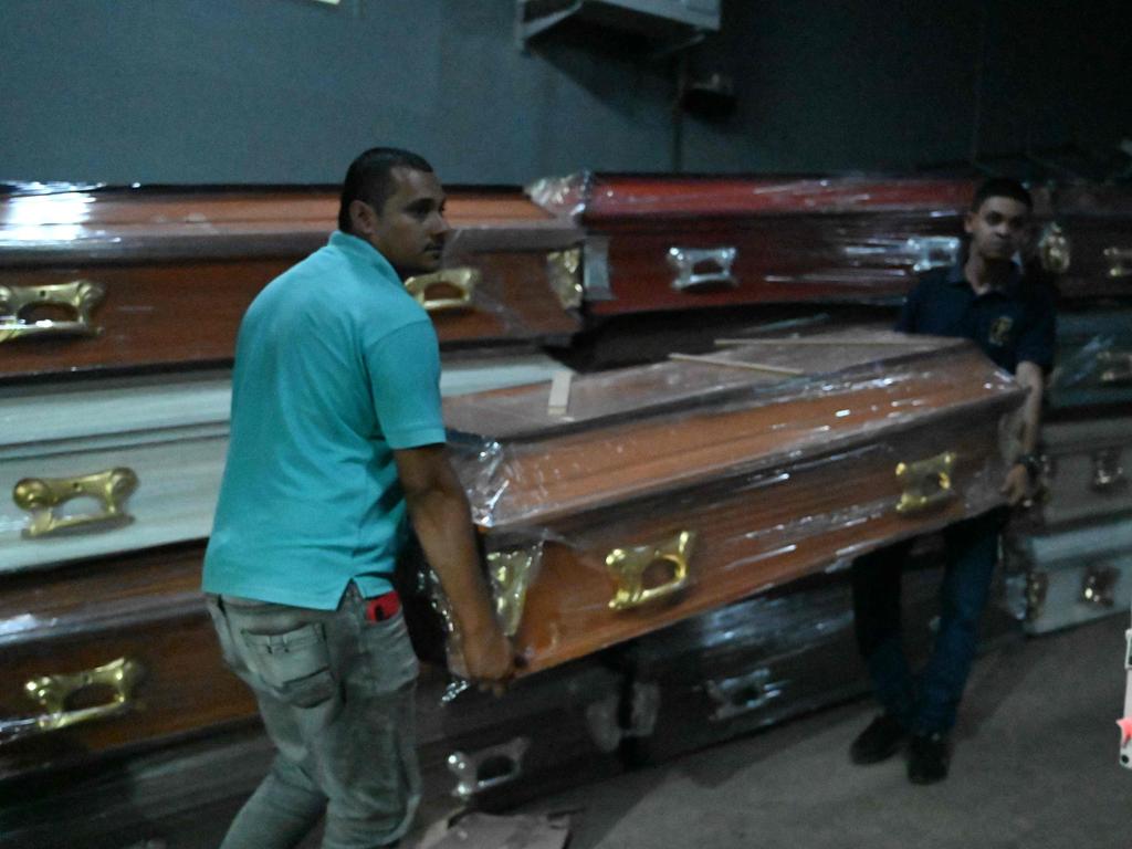 Relatives of inmates carry coffins after a fire at the prison in Tamara. (Photo by Orlando SIERRA / AFP)