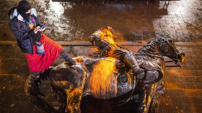 A protester stands on a toppled statue of US president Theodore Roosevelt in Portland, Oregon, in 2020. Picture: Getty Images