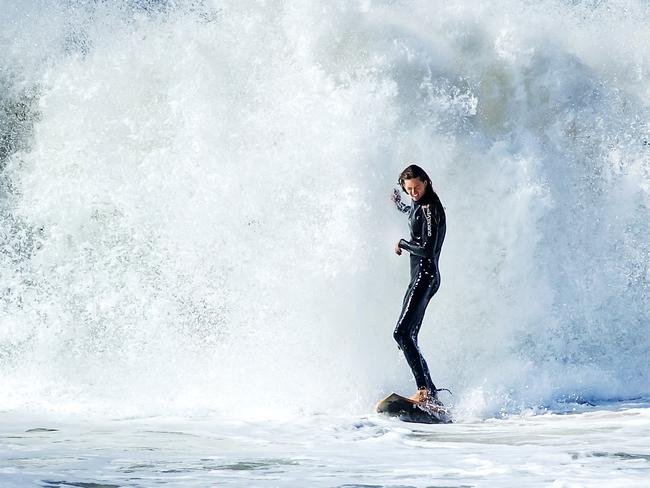 A surfer is dwarfed by whitewater at Sunshine Beach as a southerly swell from an east coast low pushes big waves into southeast Queensland. Picture: Lachie Millard