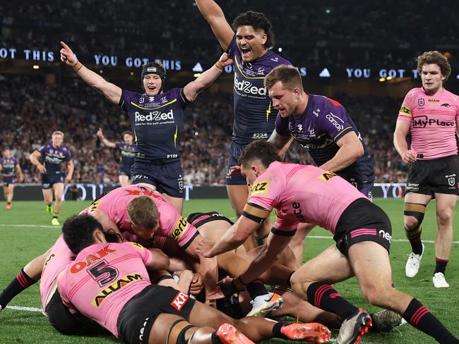 SYDNEY, AUSTRALIA - OCTOBER 06:  Jack Howarth of the Storm is help up over the try-line during the 2024 NRL Grand Final match between the Melbourne Storm and the Penrith Panthers at Accor Stadium on October 06, 2024, in Sydney, Australia. (Photo by Cameron Spencer/Getty Images)