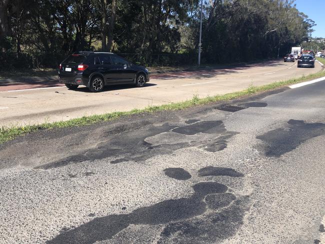 A series of repaired and damaged potholes on Pittwater Rd at Dee Why on Thursday. The road is managed by the NSW Government. Picture: Jim O'Rourke