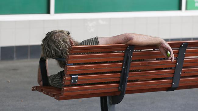 A man sleeps on a public bench in Abbott St. Picture: Brendan Radke