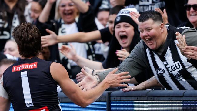 MELBOURNE, AUSTRALIA - APRIL 20: Patrick Lipinski of the Magpies celebrates a goal with the crowd during the 2024 AFL Round 06 match between the Collingwood Magpies and the Port Adelaide Power at the Melbourne Cricket Ground on April 20, 2024 in Melbourne, Australia. (Photo by Dylan Burns/AFL Photos via Getty Images)