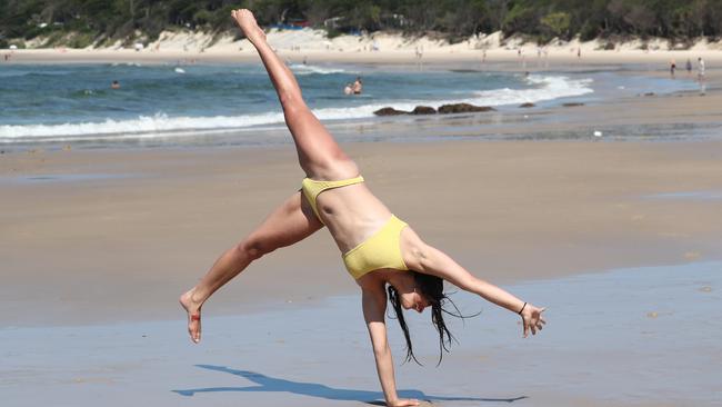 Schoolie Miya Simpson, 18, has fun at Clarkes Beach in Byron Bay. Photograph: Jason O'Brien