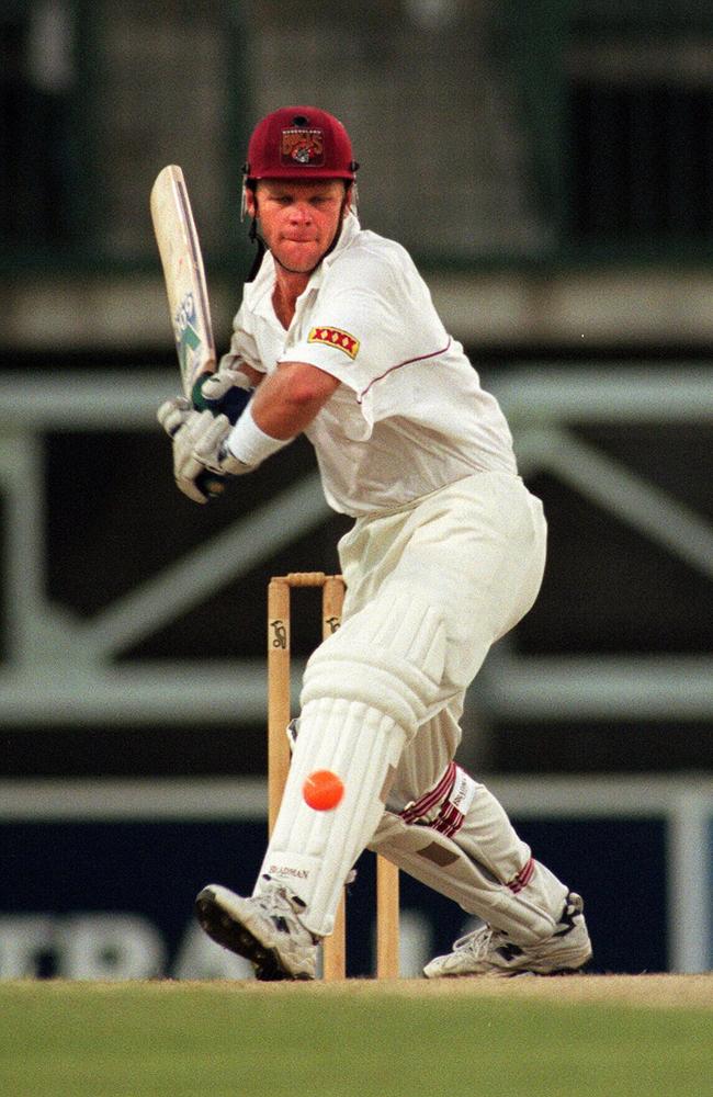 Sandgate-Redcliffe’s Trevor Barsby playing against an orange ball at night.