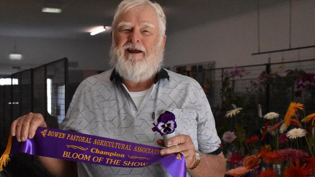 Neil Tracey of Bowen has been exhibiting at the Bowen Show for about 50 years, inspired by his late mother Nancy – a keen amateur gardener who instilled a love of beautiful blooms and homegrown veggies in her three sons. This year, Mr Tracey won Champion Single Rose for a very delicate striped bush rose, and Bloom of the Show for some stunning pansies. Picture: Kirra Grimes