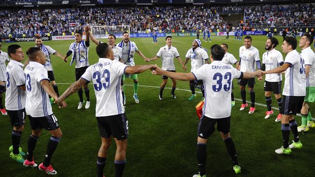 Real Madrid's players celebrate at the end of a the match.