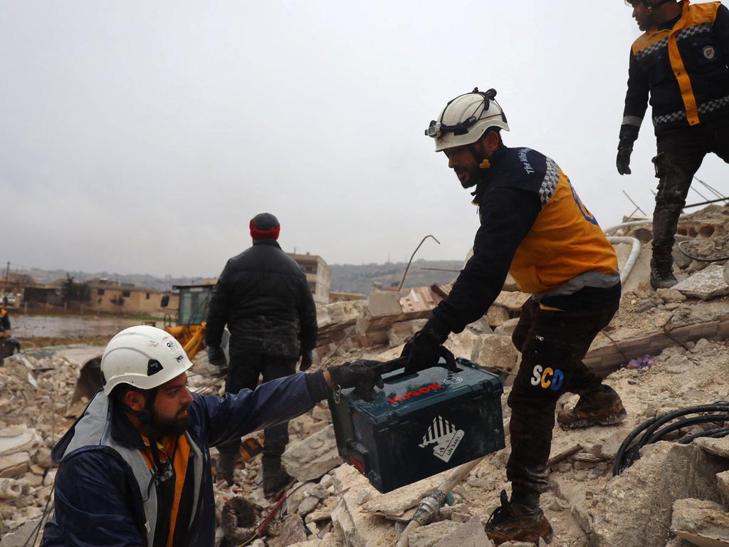 Members of the Syrian civil defence, known as the White Helmets look for casualties under the rubble following an earthquake in the town of Sarmada in the countryside of the northwestern Syrian Idlib province. Picture: AFP