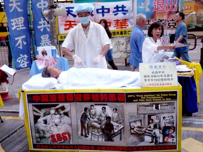 A pro Falun Gong protestor simulates an ‘organ harvesting’ procedure in Hong Kong. Picture: Cory Doctorow/Flickr