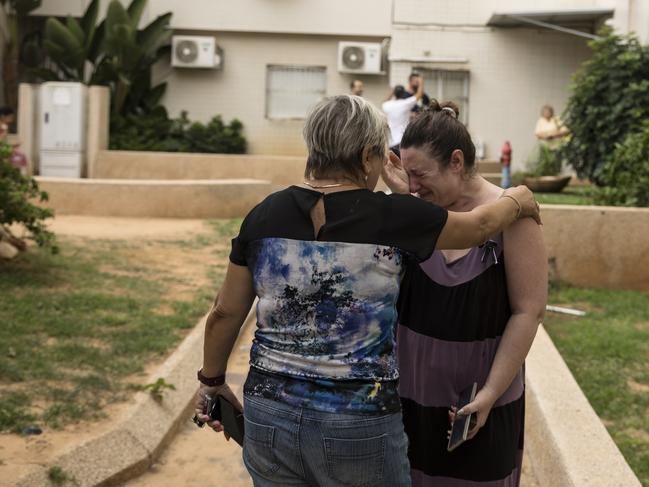 Women in Asdod, Israel, after a rocket fired from the Gaza Strip hit a street in on October 9. Picture: Getty Images