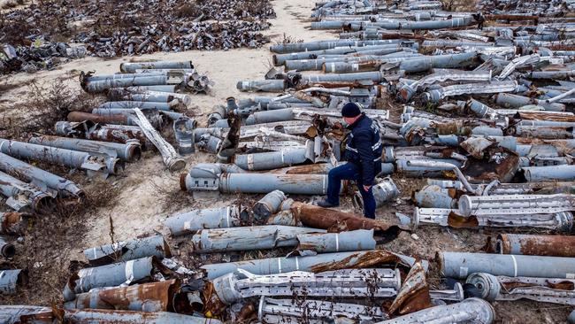 This aerial picture shows an expert of the prosecutor's office examining collected remnants of shells and missiles used by the Russian army to attack the second largest Ukrainian city of Kharkiv, amid the Russian invasion of Ukraine. Picture: AFP