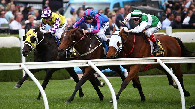 Toydini (centre) lifts to reel in Speediness (rails) as Sacred Falls closes fast. Picture: George Salpigtidis