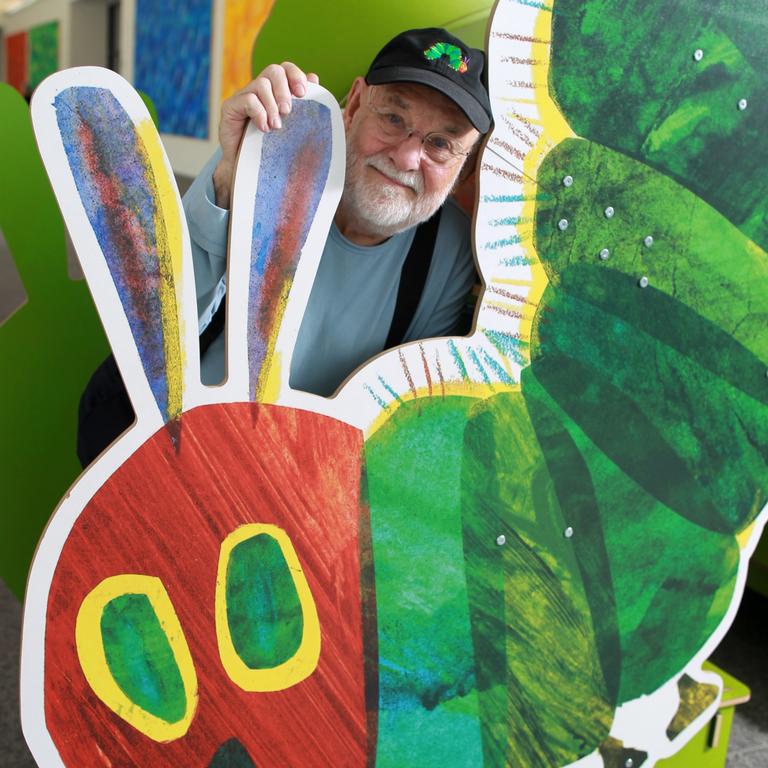 AMHERST, MA - SEPTEMBER 27: Eric Carle stands with large cutout of the iconic image from his children's book, "The Very Hungry Caterpillar," at The Eric Carle Museum. Picture: Jonathan Wiggs/The Boston Globe via Getty Images