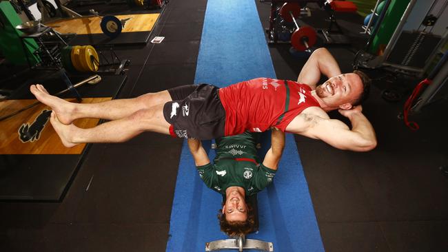 Rabbitohs' strongest man Campbell Graham bench pressing teammate Damien Cook. Picture: Richard Dobson