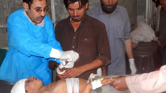 Pakistani paramedics treat an injured blast victim at a hospital in Bajaur Agency near the Pakistan-Afghanistan border following a suicide bombing at a mosque in the Mohmand tribal district. Picture: AFP
